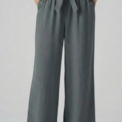 Green women's trousers with elastic waist and tie belt by THE WHITMORE FAMILY, shown on a model.