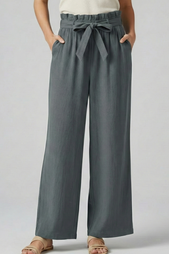 Green women's trousers with elastic waist and tie belt by THE WHITMORE FAMILY, shown on a model.