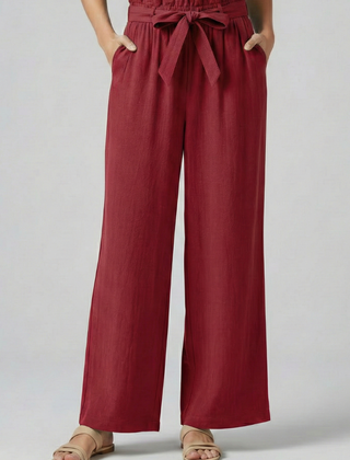 Green women's trousers with elastic waistband and tie belt by THE WHITMORE FAMILY, shown on a model.