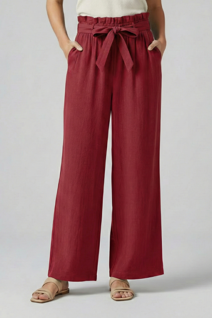 Green women's trousers with elastic waistband and tie belt by THE WHITMORE FAMILY, shown on a model.