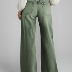Women’s green wide-leg jeans with high-rise waist and front closure, from THE WHITMORE FAMILY, shown on a model.