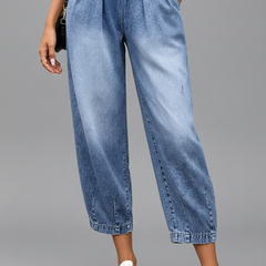 Women’s cropped trousers by THE WHITMORE FAMILY featuring a drawstring waist and pleats, shown in a stylish fit and fabric.