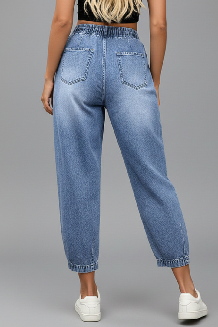 Women’s cropped trousers with drawstring waist and pleats from THE WHITMORE FAMILY, featuring a relaxed fit and stylish design.