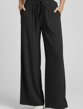 Light blue women’s palazzo trousers with drawstring waist and side pockets by THE WHITMORE FAMILY.