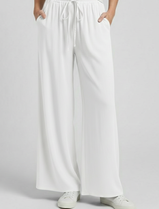 Light blue women’s palazzo trousers with drawstring waist and side pockets from THE WHITMORE FAMILY.