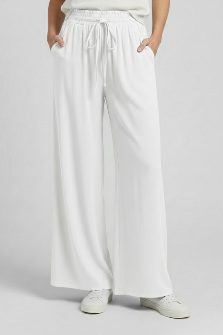 Light blue women’s palazzo trousers with drawstring waist and side pockets from THE WHITMORE FAMILY.