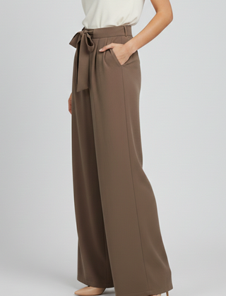Light blue women’s Palazzo trousers by THE WHITMORE FAMILY with drawstring waist and side pockets, casual and comfortable fit.