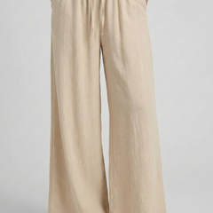 Light blue women's palazzo trousers by THE WHITMORE FAMILY with drawstring waist and side pockets, made for comfortable stylish wear.