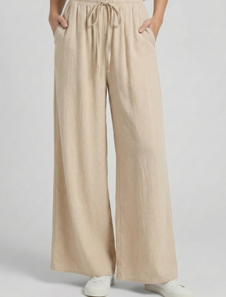 Light blue women's palazzo trousers by THE WHITMORE FAMILY with drawstring waist and side pockets, made for comfortable stylish wear.