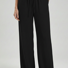 Light blue women’s palazzo trousers with drawstring waist and side pockets by THE WHITMORE FAMILY.