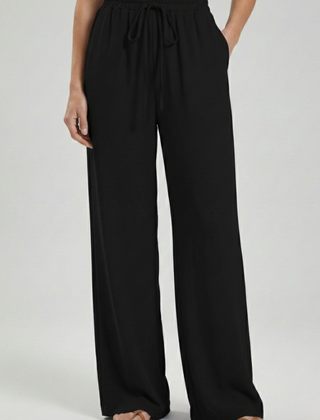 Light blue women’s palazzo trousers with drawstring waist and side pockets by THE WHITMORE FAMILY.