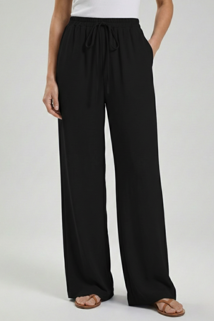 Light blue women’s palazzo trousers with drawstring waist and side pockets by THE WHITMORE FAMILY.