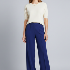 Women’s high-waist palazzo trousers with pleats from THE WHITMORE FAMILY, featuring a flowy fit and elegant design.