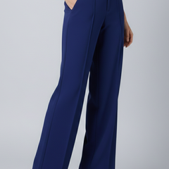 Navy blue women's palazzo trousers with high waist and pleats by THE WHITMORE FAMILY, shown on a model.