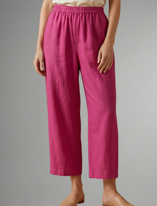 Pink women’s trousers with elastic waistband and wide-leg design from THE WHITMORE FAMILY, perfect for casual and stylish wear.