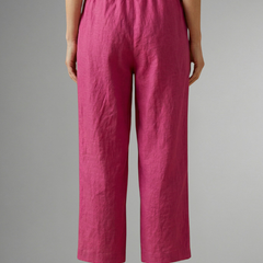 Women's pink trousers with elastic waistband and wide-leg fit from THE WHITMORE FAMILY, showcasing comfortable, flowy fabric.
