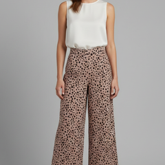 Pink women's palazzo trousers with high waist and polka dot pattern from THE WHITMORE FAMILY, shown on a model.