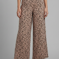 Women's Palazzo Trousers with high waist and pink polka dot pattern, by THE WHITMORE FAMILY, shown on a model.