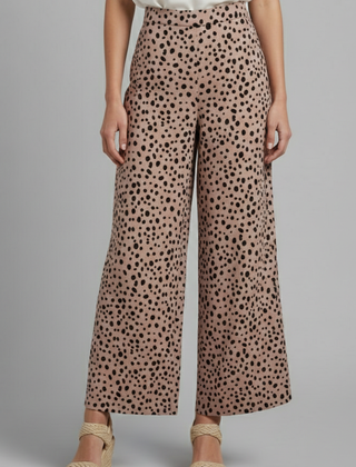 Women's Palazzo Trousers with high waist and pink polka dot pattern, by THE WHITMORE FAMILY, shown on a model.