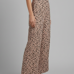 Women’s pink palazzo trousers with high waist and polka dot pattern from THE WHITMORE FAMILY, shown flat on a white background.