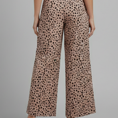 Women's pink Palazzo trousers with high waist and polka dot pattern from THE WHITMORE FAMILY, shown flat on a white background.