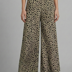 Women’s pink palazzo trousers with high waist and polka dot pattern by THE WHITMORE FAMILY, shown on a model.