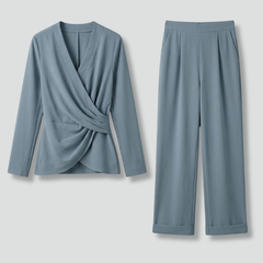Women’s two-piece set by THE WHITMORE FAMILY featuring a wrap top and cropped trousers, styled for casual or chic wear.