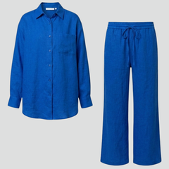 Beige women's two-piece set with button shirt and straight trousers by THE WHITMORE FAMILY, styled for a casual or office look.
