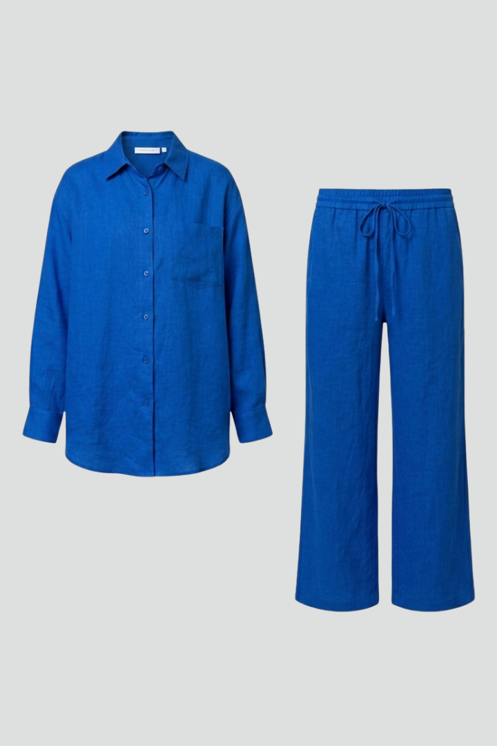 Beige women's two-piece set with button shirt and straight trousers by THE WHITMORE FAMILY, styled for a casual or office look.