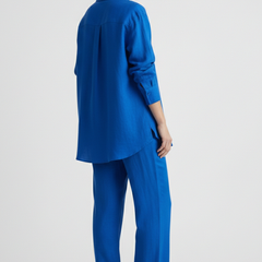 Beige women's two-piece set with button shirt and straight trousers by THE WHITMORE FAMILY, shown on a model.