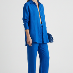 Beige women's two-piece set with button shirt and straight trousers from THE WHITMORE FAMILY, shown on a model.