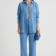 Beige women's two-piece set with button shirt and straight trousers by THE WHITMORE FAMILY, styled for a casual or professional look.