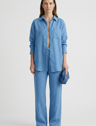 Beige women's two-piece set with button shirt and straight trousers by THE WHITMORE FAMILY, styled for a casual or professional look.