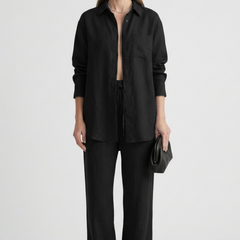Beige women’s two-piece set with button shirt and straight trousers by THE WHITMORE FAMILY, styled for casual or office wear.