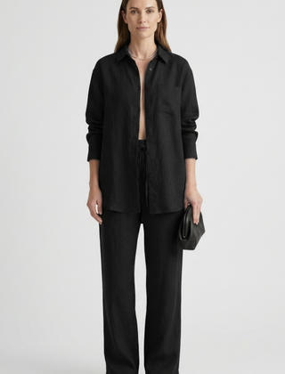 Beige women’s two-piece set with button shirt and straight trousers by THE WHITMORE FAMILY, styled for casual or office wear.