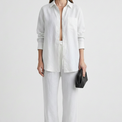 Beige women’s two-piece set with button shirt and straight trousers by THE WHITMORE FAMILY, styled for a casual look.