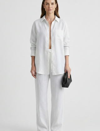 Beige women’s two-piece set with button shirt and straight trousers by THE WHITMORE FAMILY, styled for a casual look.