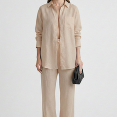 Women’s beige two-piece set by THE WHITMORE FAMILY featuring a button shirt and straight trousers, perfect for casual or office wear.