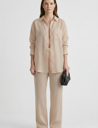 Women’s beige two-piece set by THE WHITMORE FAMILY featuring a button shirt and straight trousers, perfect for casual or office wear.
