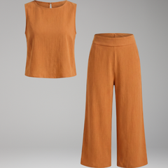 Beige women's two-piece set by THE WHITMORE FAMILY with sleeveless top and cropped trousers, styled for casual or office wear.