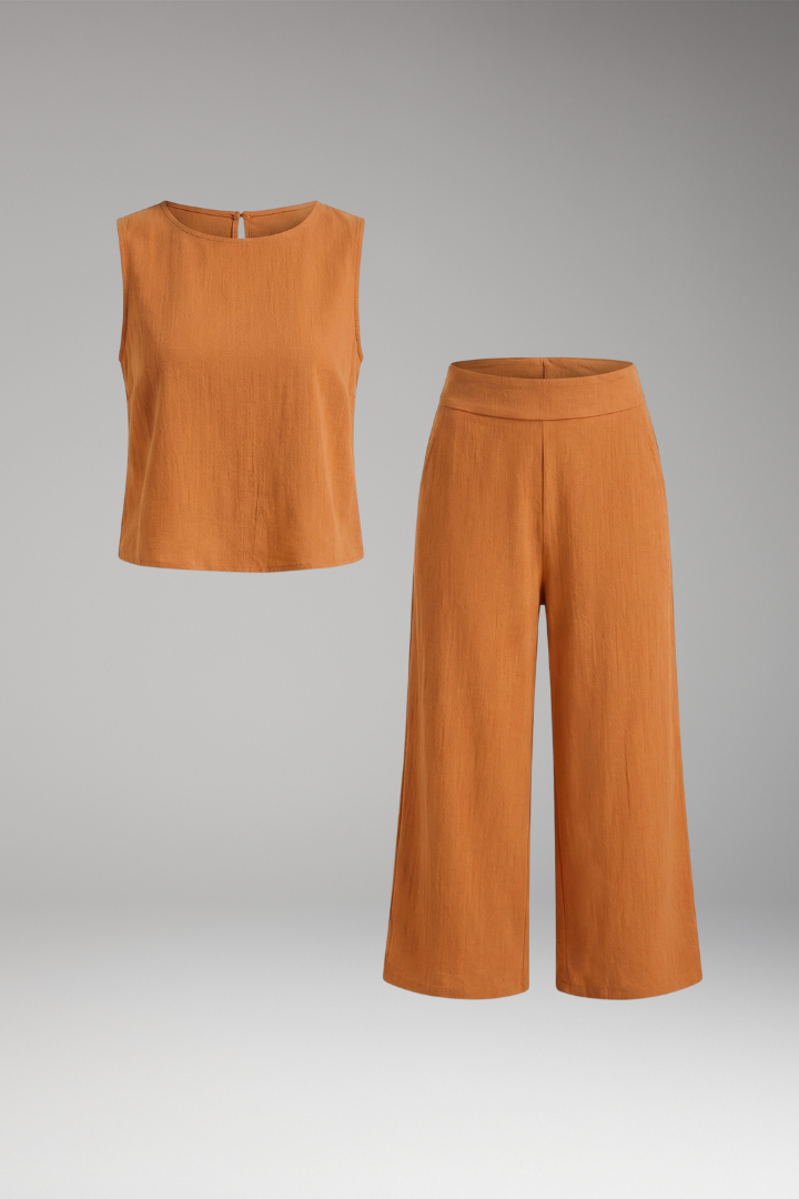 Beige women's two-piece set by THE WHITMORE FAMILY with sleeveless top and cropped trousers, styled for casual or office wear.