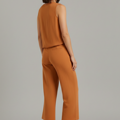 Beige women's two-piece set with sleeveless top and cropped trousers from THE WHITMORE FAMILY, stylish and comfortable.