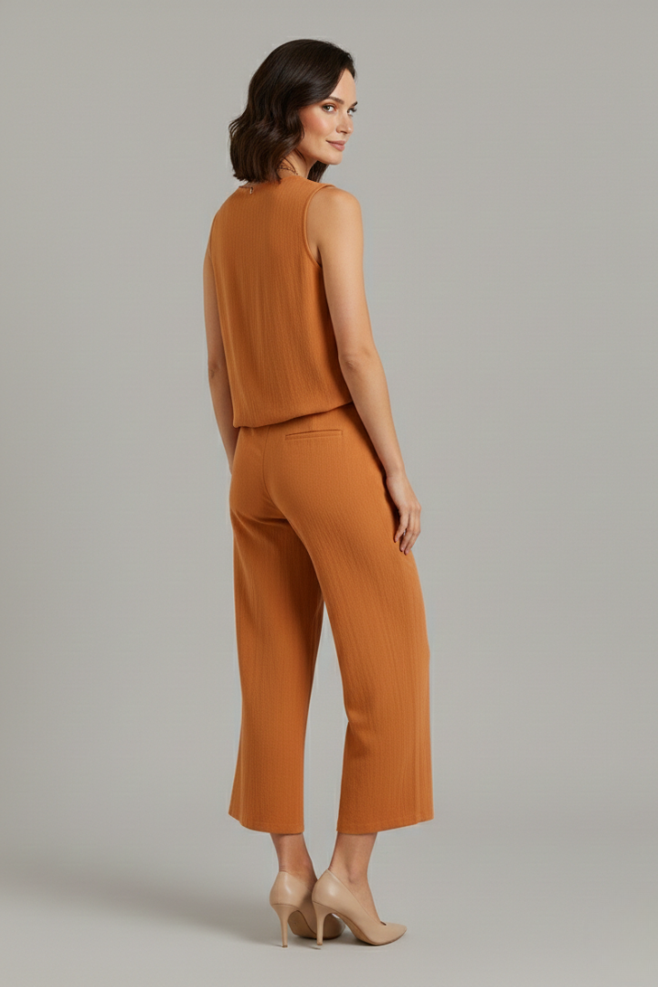 Beige women's two-piece set with sleeveless top and cropped trousers from THE WHITMORE FAMILY, stylish and comfortable.