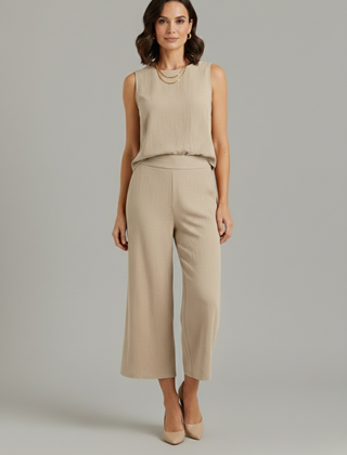 Women’s beige two-piece set by THE WHITMORE FAMILY featuring a sleeveless top and cropped trousers, casual and stylish.
