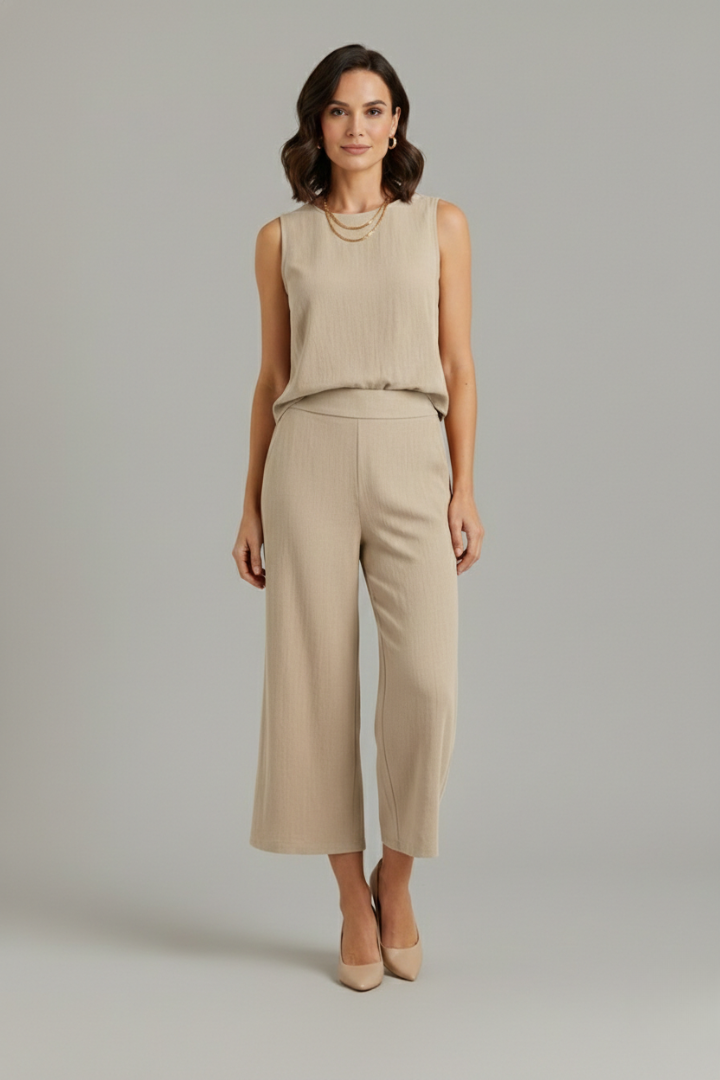 Women’s beige two-piece set by THE WHITMORE FAMILY featuring a sleeveless top and cropped trousers, casual and stylish.