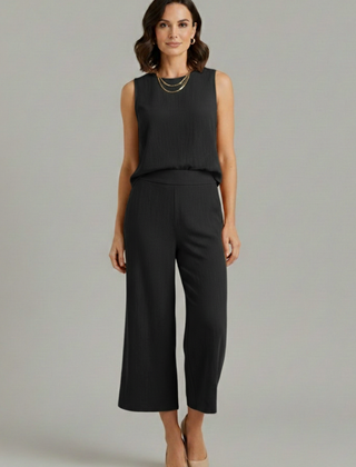 Beige women's two-piece set by THE WHITMORE FAMILY featuring a sleeveless top and cropped trousers, stylish and comfortable.