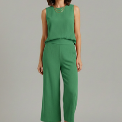 Beige women’s two-piece set with sleeveless top and cropped trousers from THE WHITMORE FAMILY, casual and stylish for warm weather.