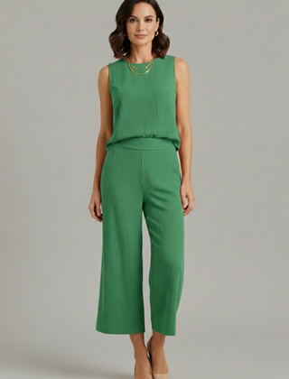 Beige women’s two-piece set with sleeveless top and cropped trousers from THE WHITMORE FAMILY, casual and stylish for warm weather.