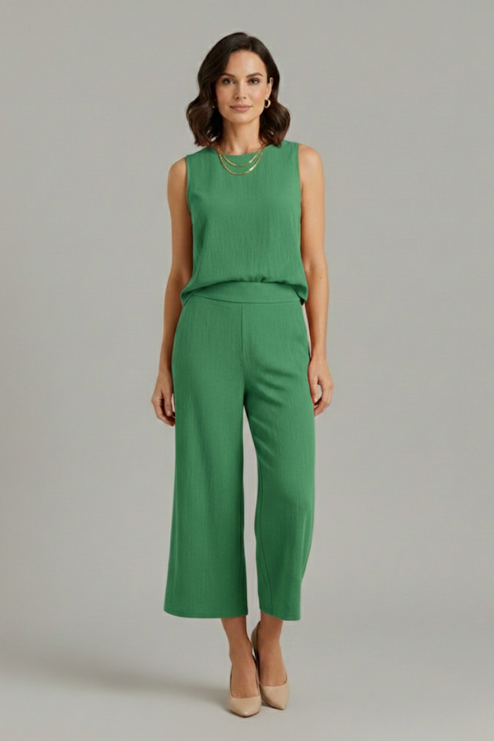 Beige women’s two-piece set with sleeveless top and cropped trousers from THE WHITMORE FAMILY, casual and stylish for warm weather.