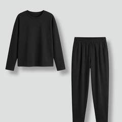 Women’s black two-piece set by THE WHITMORE FAMILY featuring a crew neck top and tapered trousers, styled together.